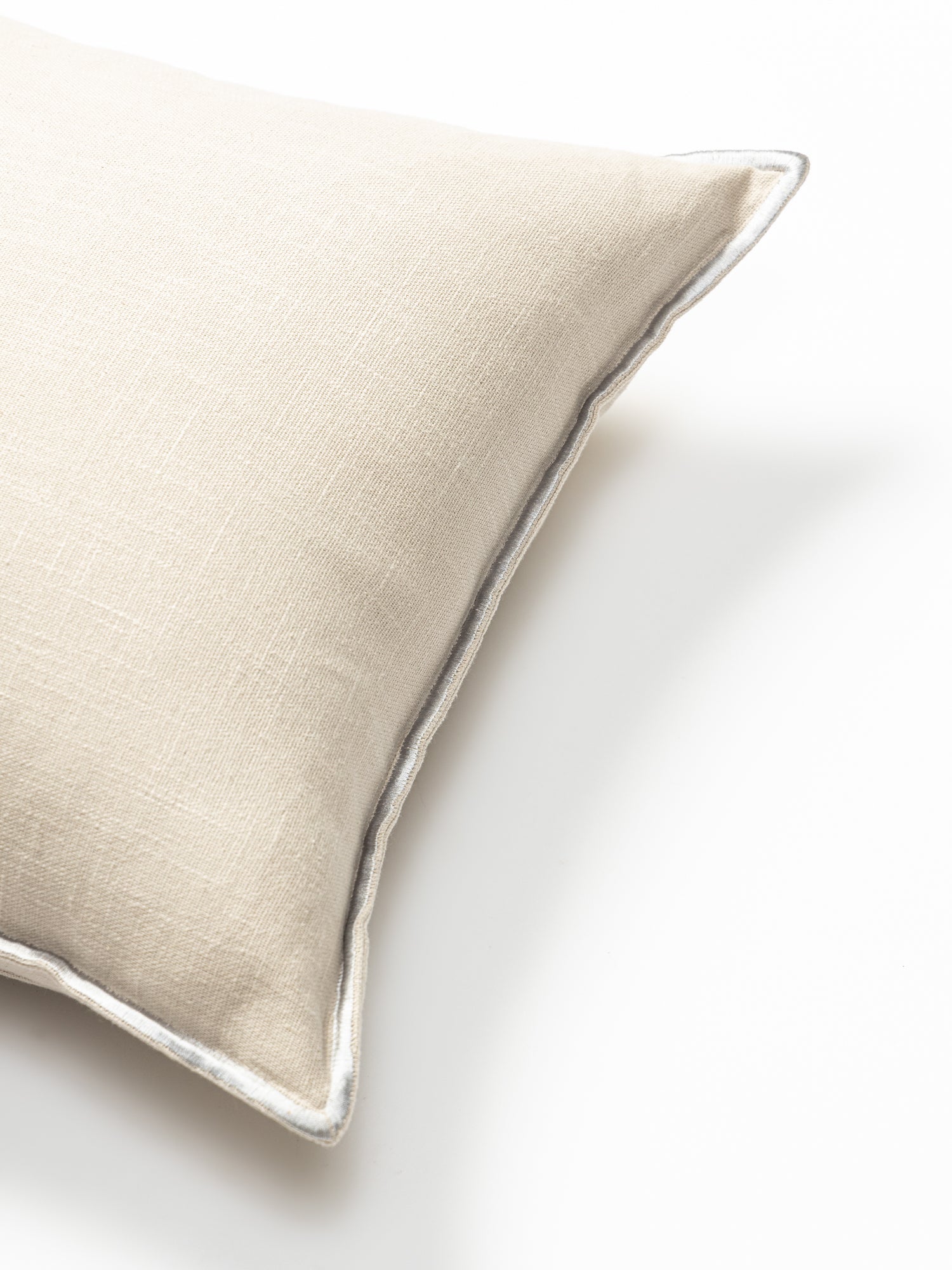 Embroidered cushion cover set in white.