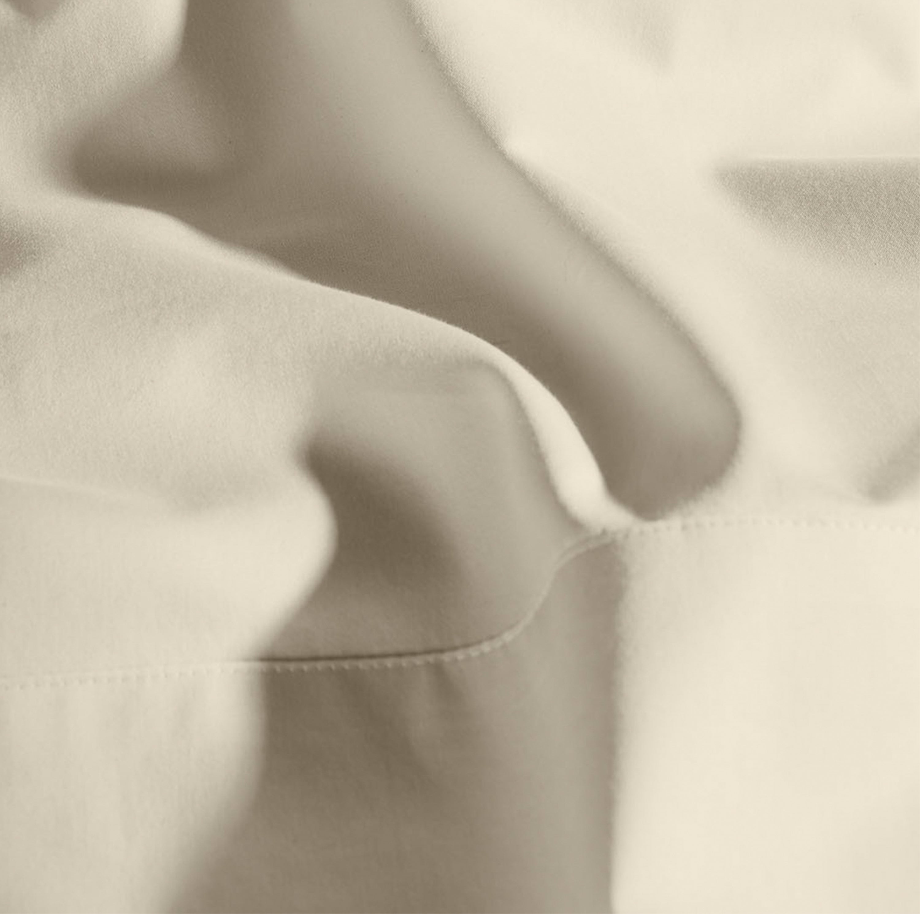 Cream bedsheet and pillow covers.