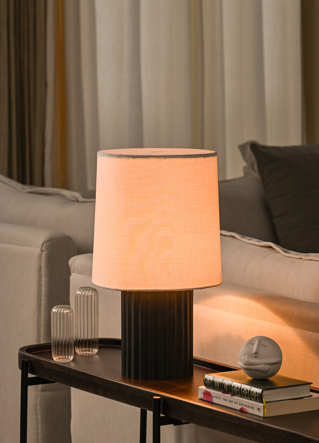 Modern table lamp on a side table with a cozy living room background