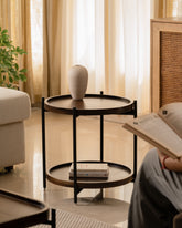Living room with neutral sofa, wood side tables, and minimalist decor.