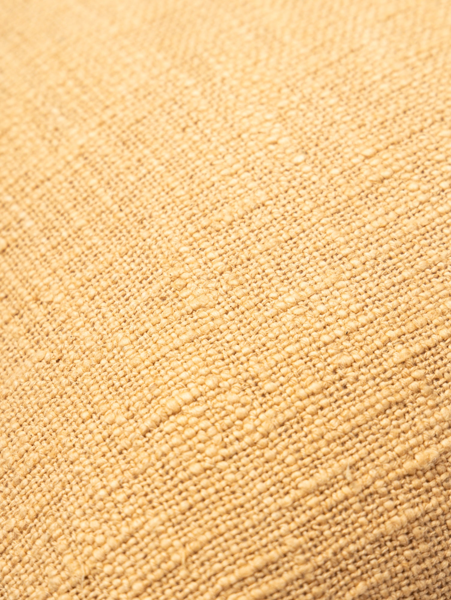 Woven beige and white cushion cover.