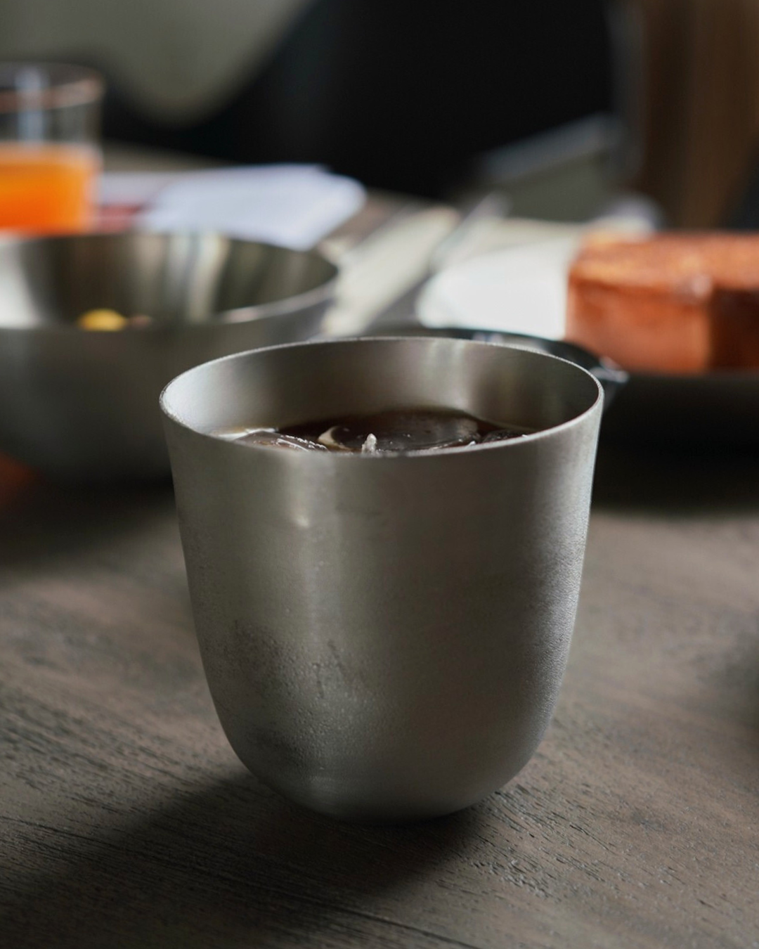 Steel tumbler with a drink in it.