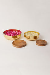 Fleck Footed Brass Urli bowl filled with flowers along with Wooden Bases