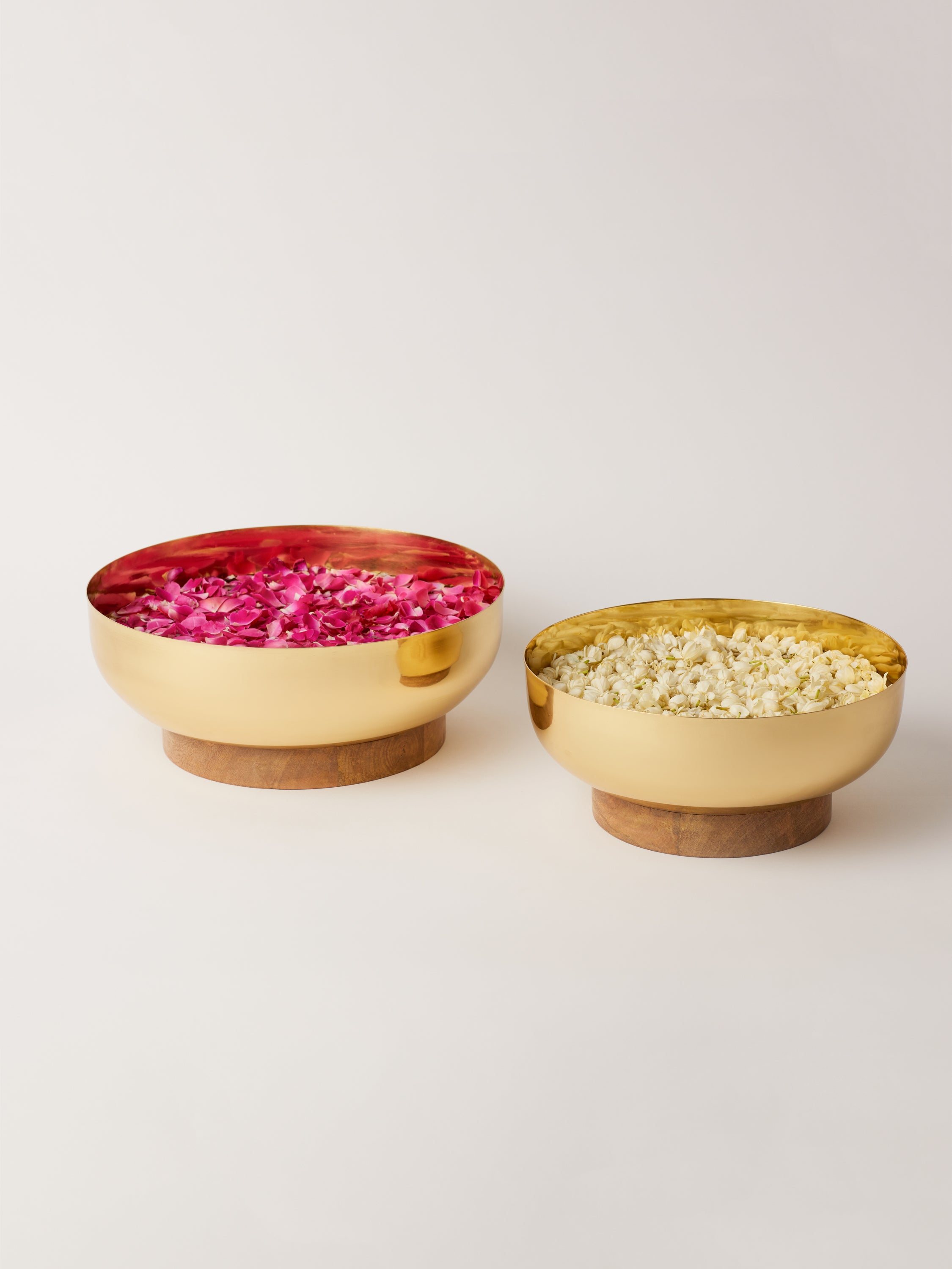Big brass bowl with wooden base for decoration.