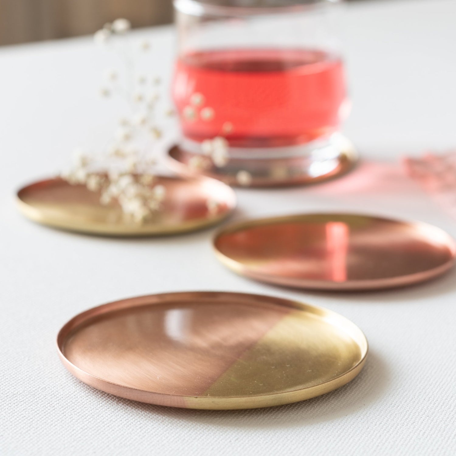 Coasters in gold and copper finish.