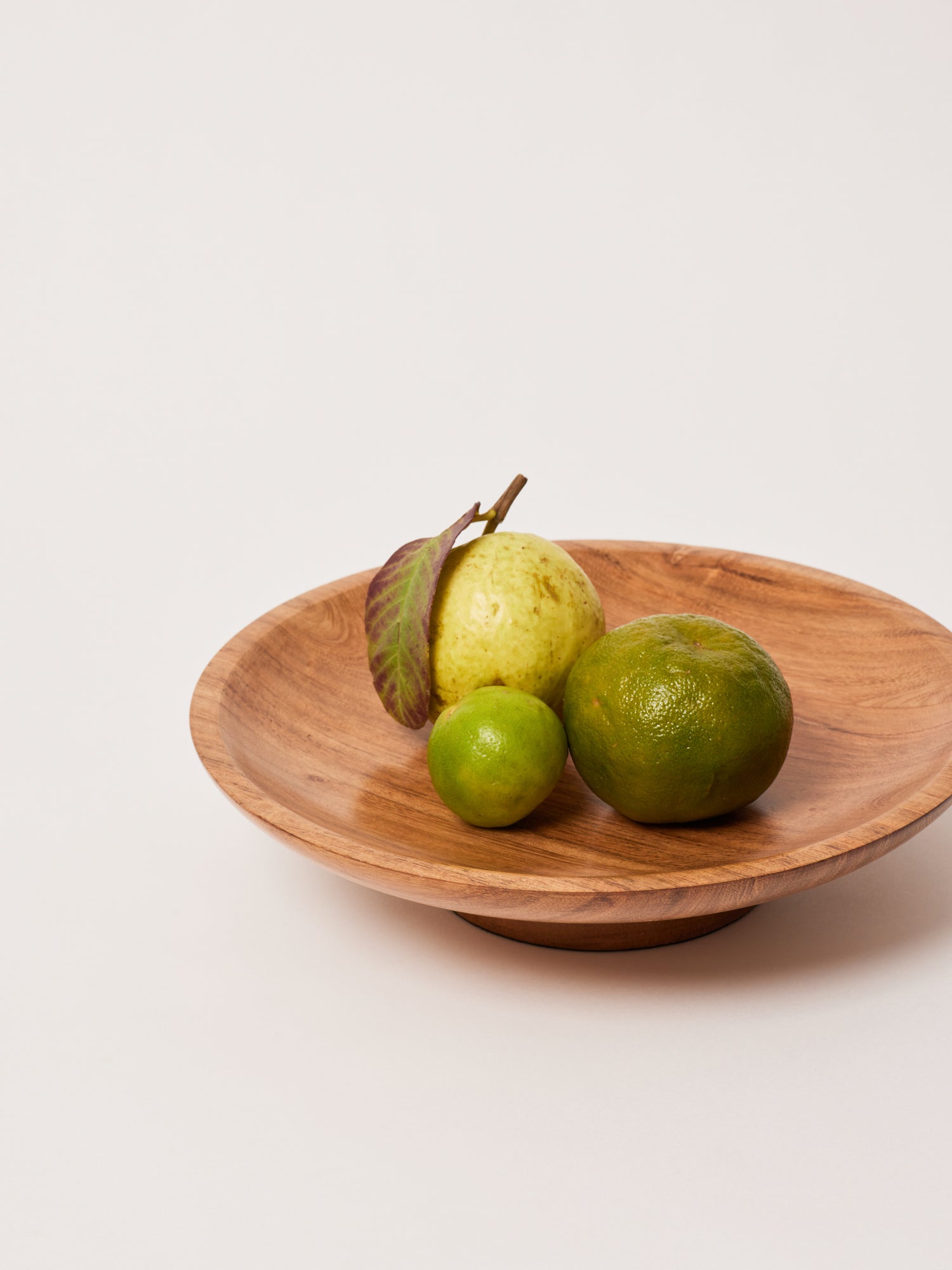 Raise wooden bowl for fruits.