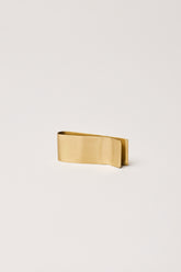 fleck brass money and paper clip side view