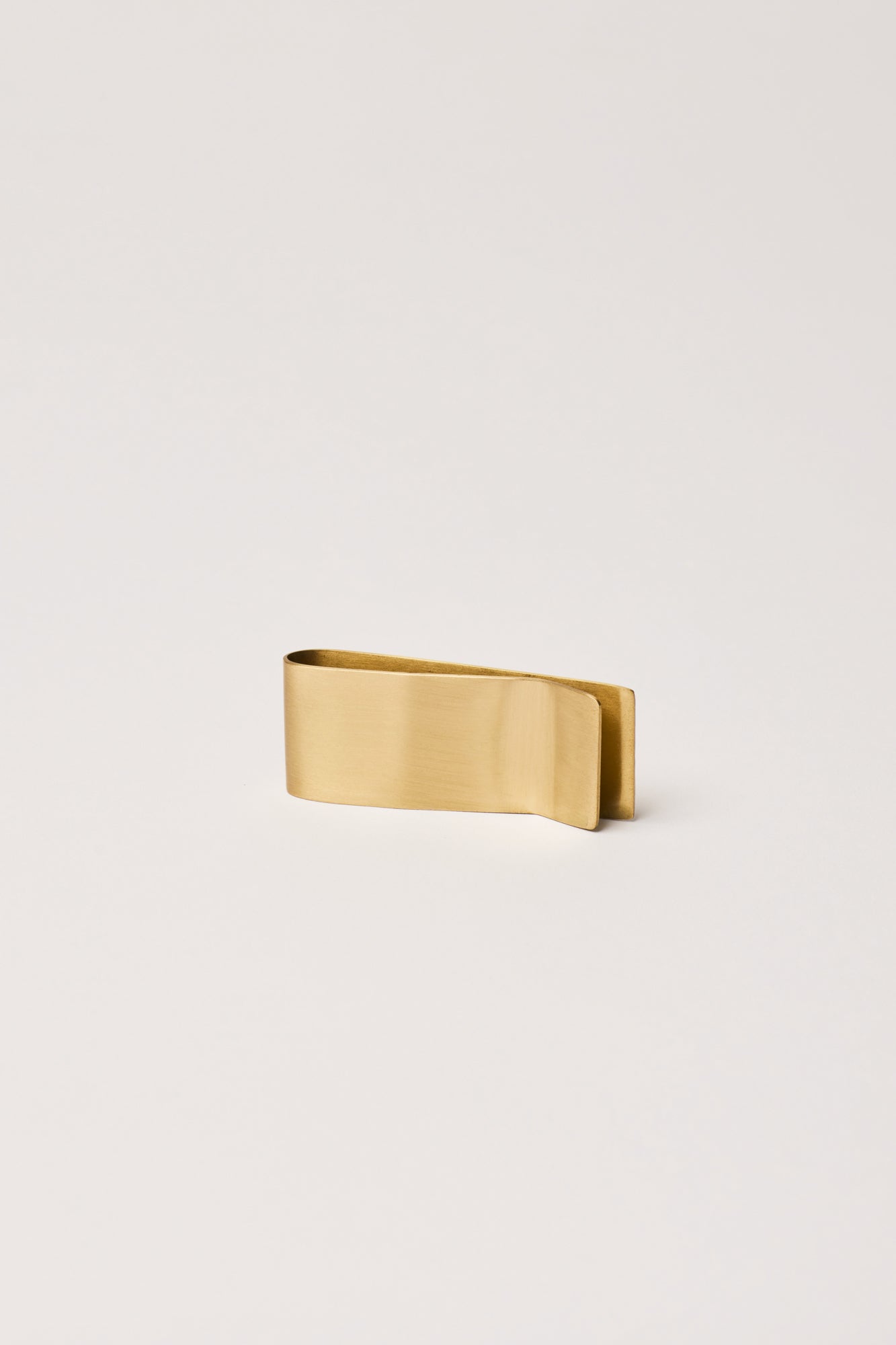 fleck brass money and paper clip side view