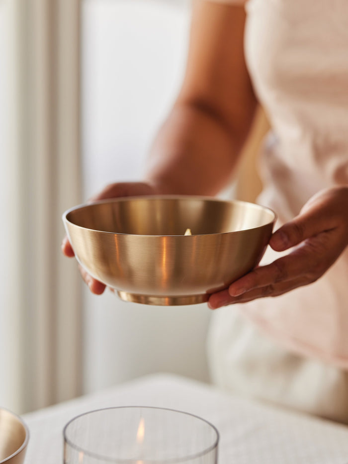 A person  holding a minimal and elegant Kansa bowl