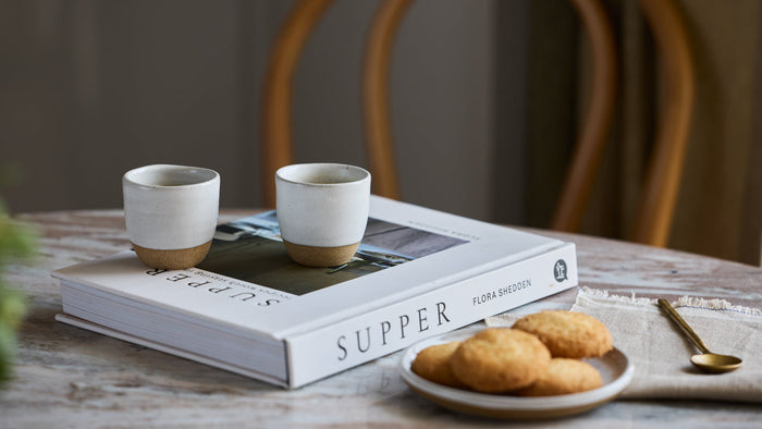 espresso in ceramic mug with cookies on the side