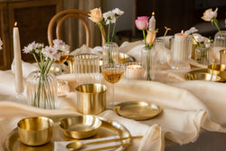 A festive table setting with brass and glass accents