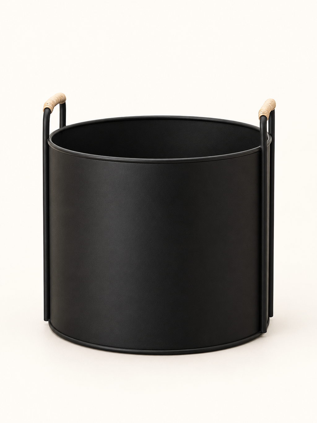 A matte black cylindrical planter or Basket with two vertical metal side supports and light natural wood handles, shown on a clean off-white background.