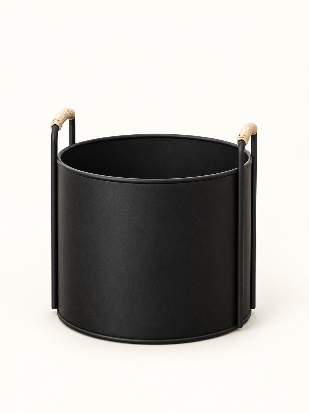 A matte black cylindrical metal planter or basket with two vertical side handles and light natural wood grips, shown on a clean white background.