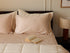 Blush Luxe Sateen Flat Sheet and Pillow with a book
