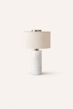 Table lamp with marble base and beige shade on a white background
