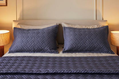 Dusk basketweave quilt and two shams made with 100% organic cotton sateen layered on a pewter bedsheet set