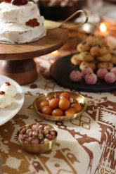 Heirloom brass tapas plate with gulab jamun in table setting