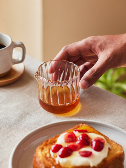 Small glass pourer for liquid.