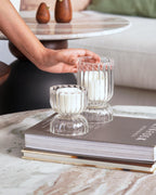 Pair of clear textured glass candle holders with minimalist white candles – perfect for cozy ambiance.
