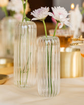 Clear glass flower vase with white and pink flowers. 