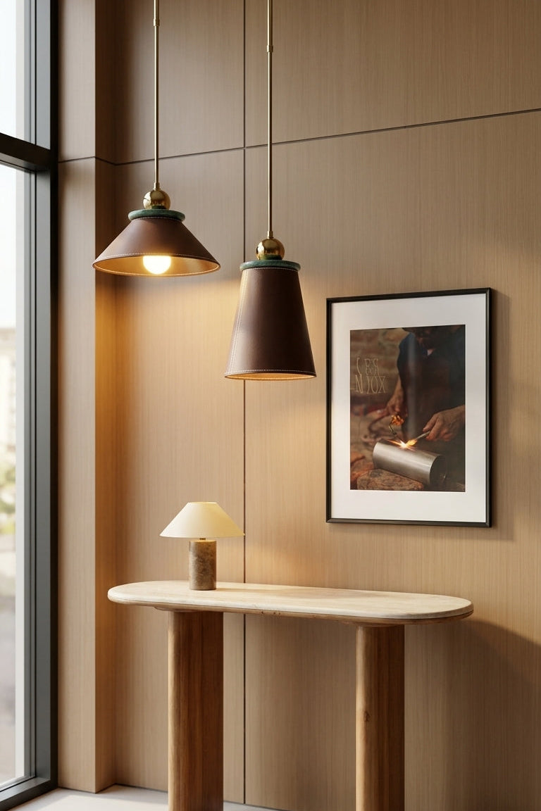 Modern interior with a wooden console table, pendant lights, and framed artwork on a beige wall.