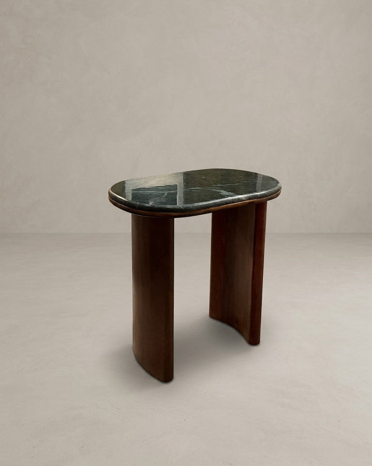 Small side table with marble top and wooden base on a plain background