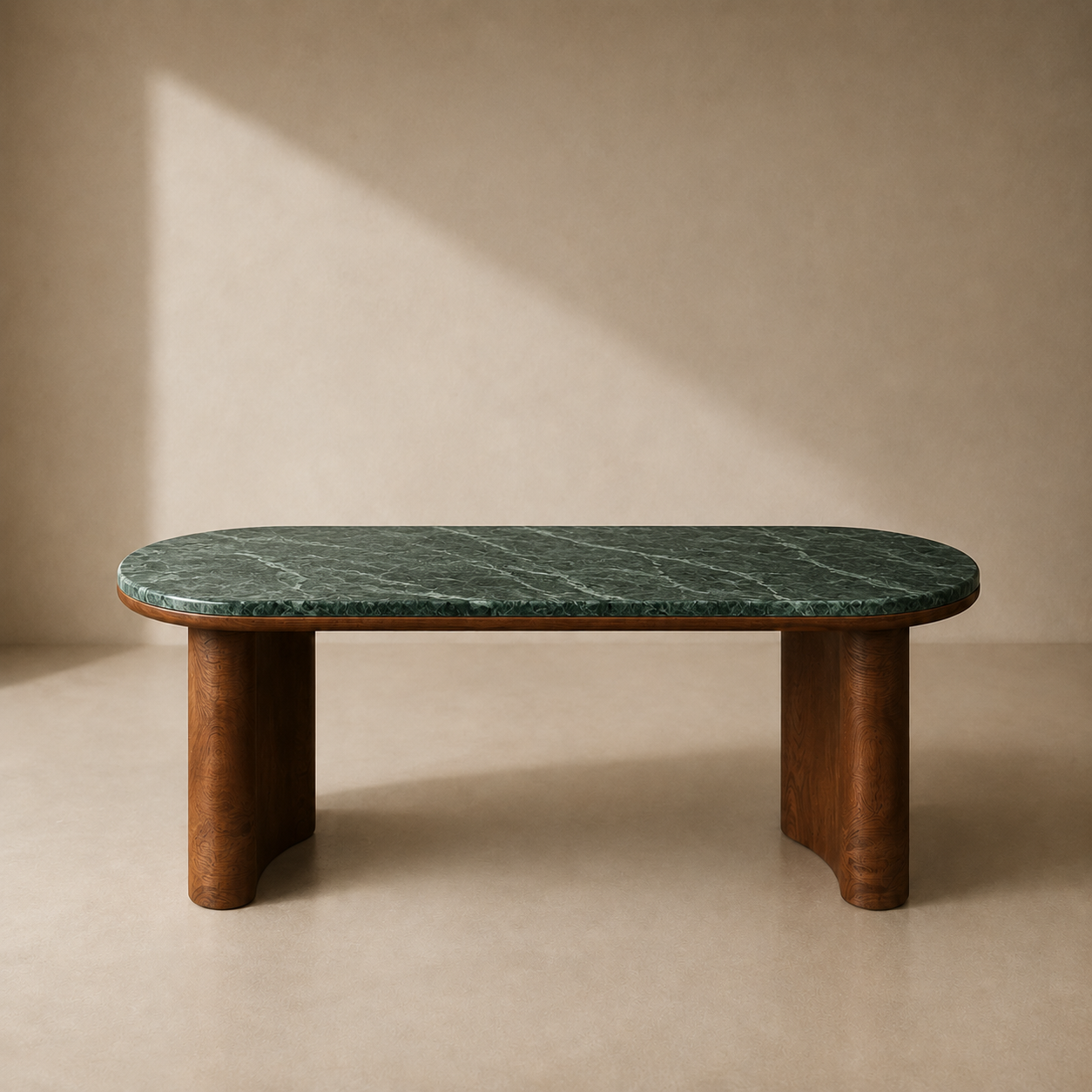 A modern low coffee table with a dark green marble top and a warm brown wooden base, set against a textured beige wall with soft diagonal sunlight.