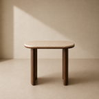 A minimalist wooden side table with a rounded rectangular top, light beige stone or marble-look surface, and dark brown tapered legs, set against a warm beige wall with a soft diagonal shadow.