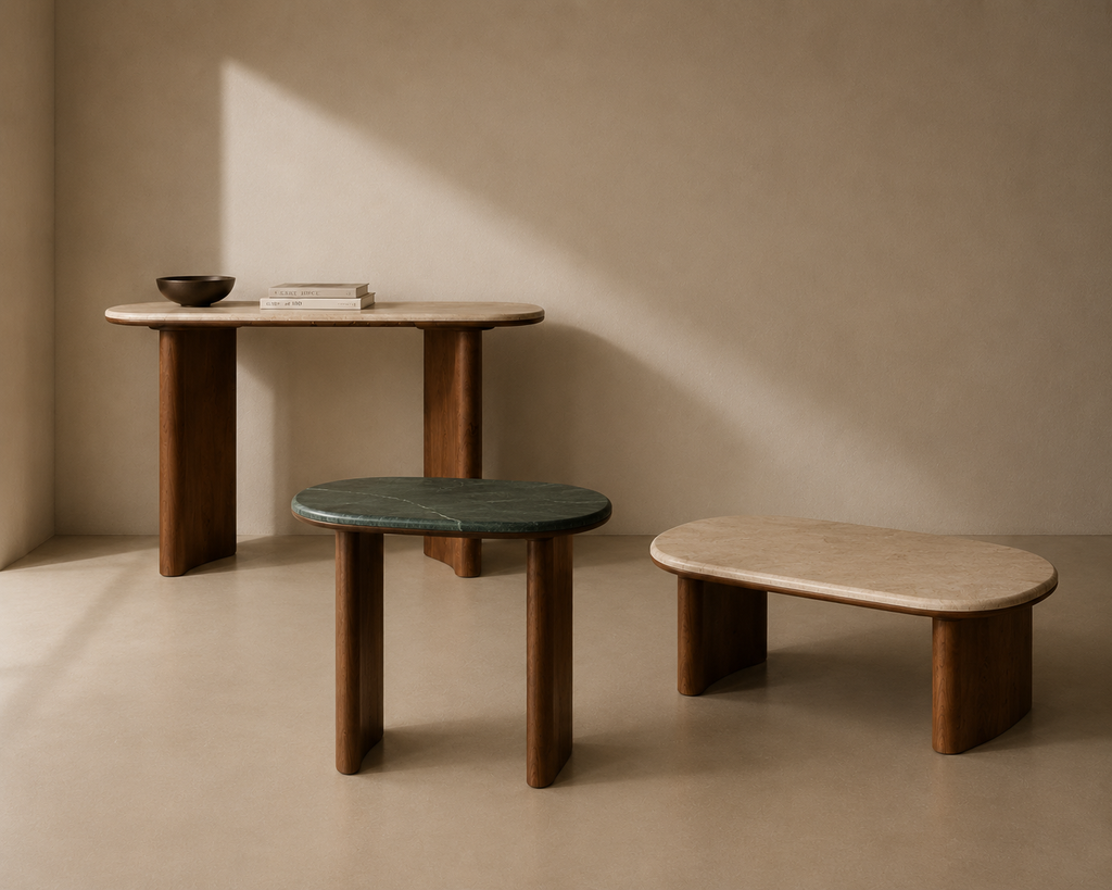 Three wood and marble tables of different sizes in a minimalistic room with soft lighting.