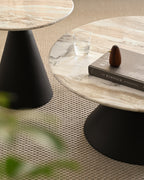 Close up of coffee and side tables with polished marble tops and bold black pedestal bases.