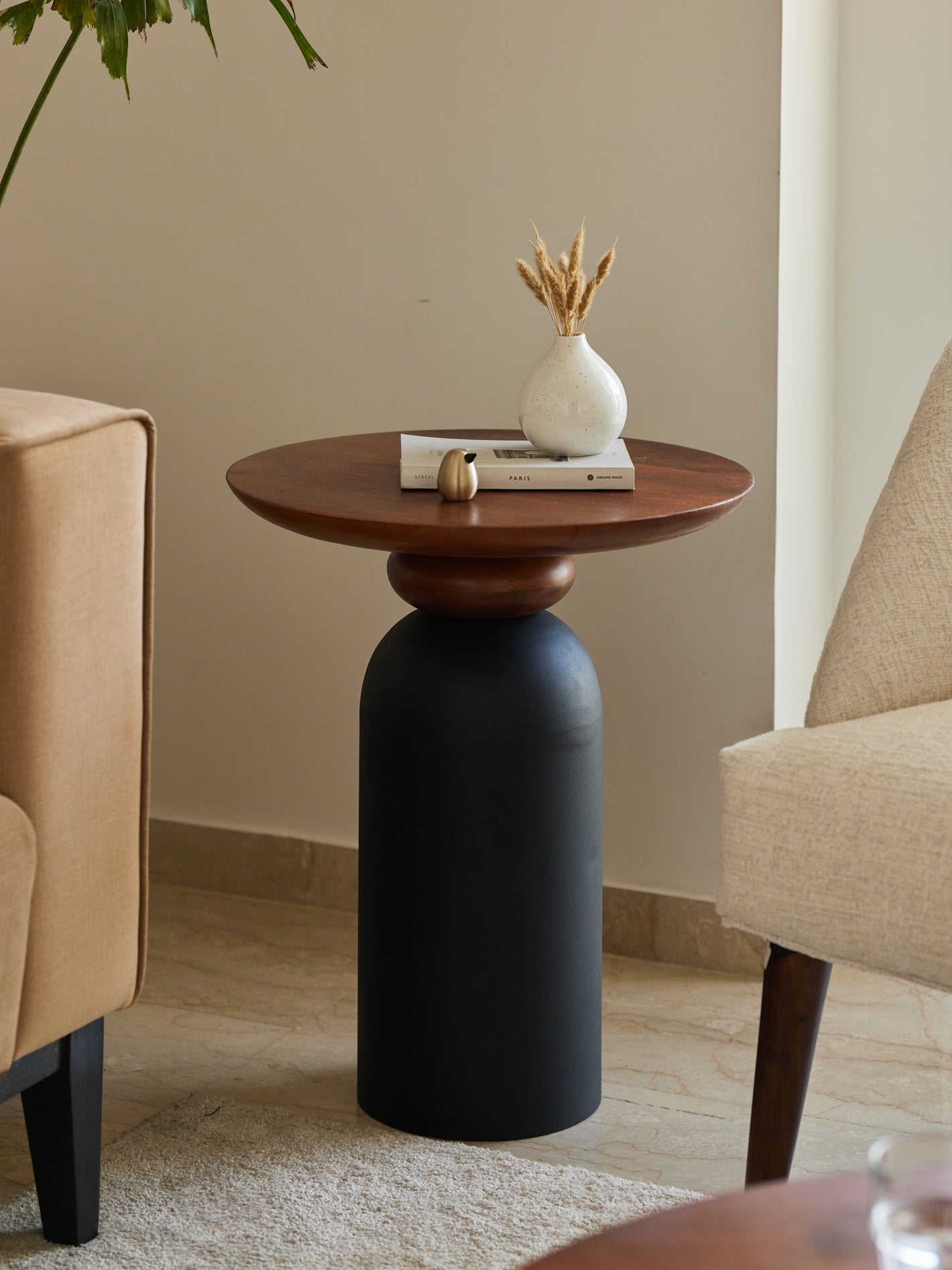 Perisi side table made with metal and solid wood in a living room setting