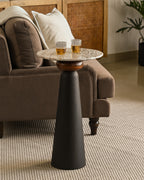 Stylish modern drinks table with marble surface and dark pedestal base in living room.