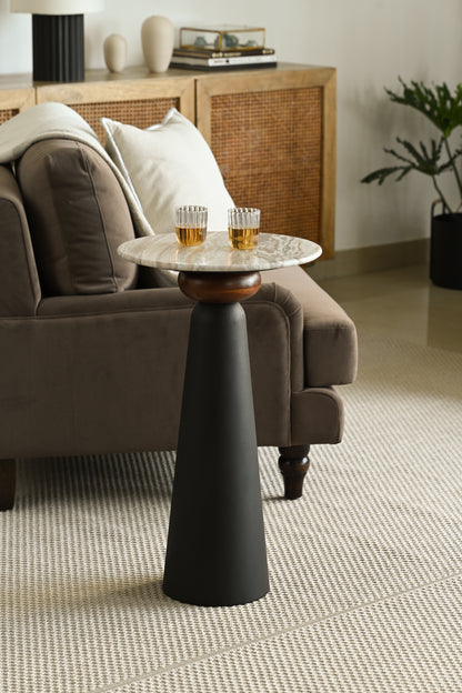 Chic modern drinks table with two drinks glasses, positioned beside a plush sofa.