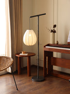 Floor lamp with white shade.