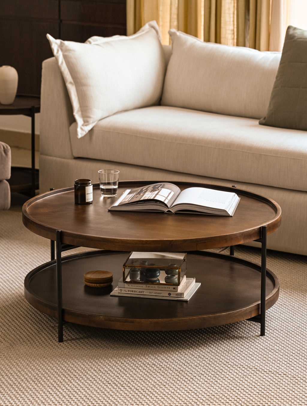 Round wooden table with living room setup 