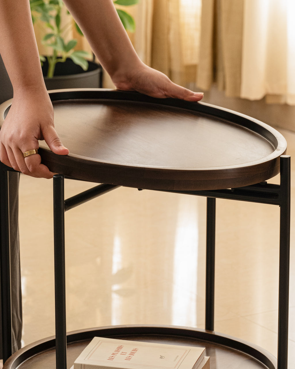 Modern round side table with lift-off wood tray and storage shelf.