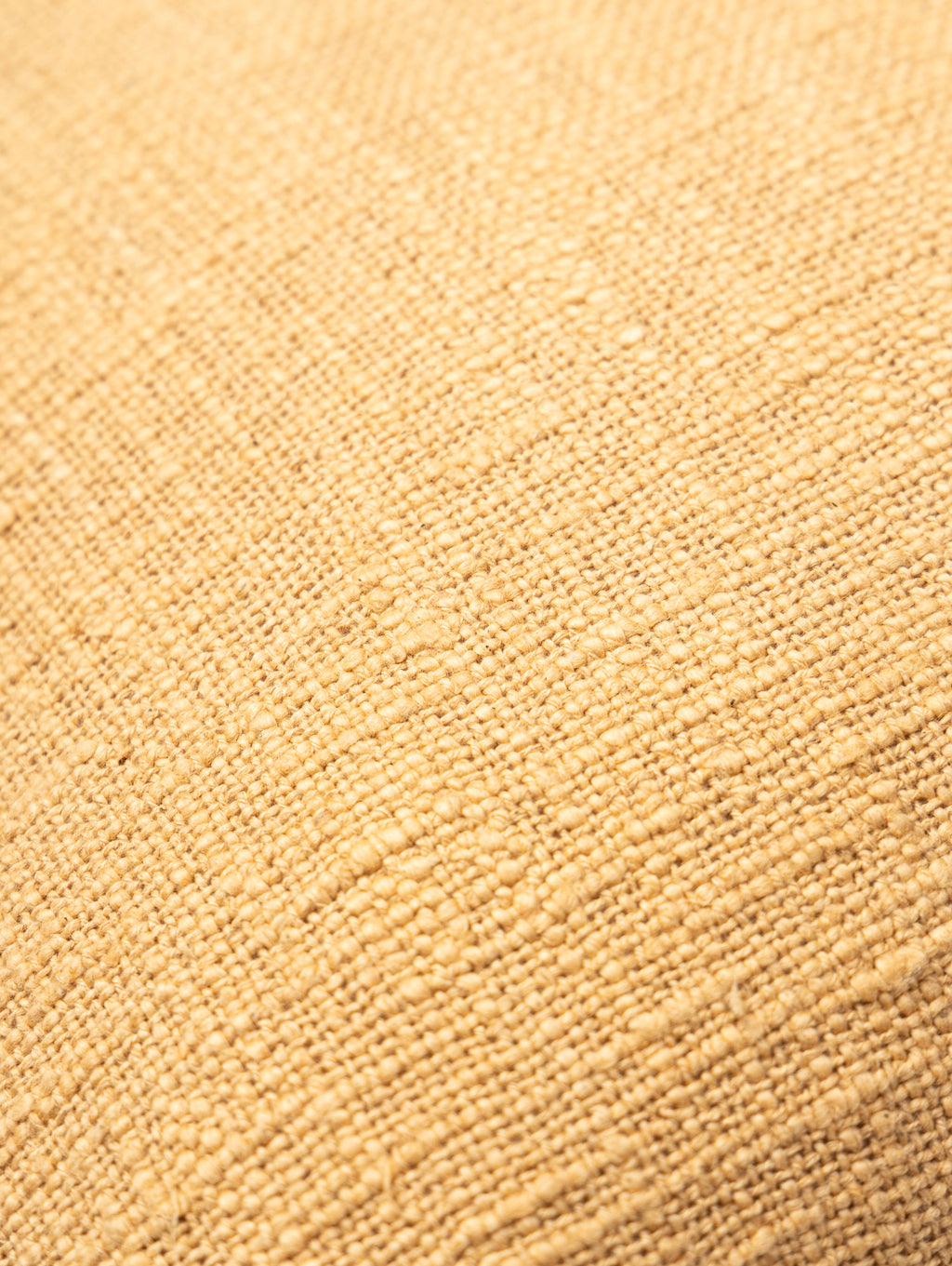Woven beige and white cushion cover.
