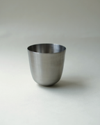 Steel tumbler with white background.