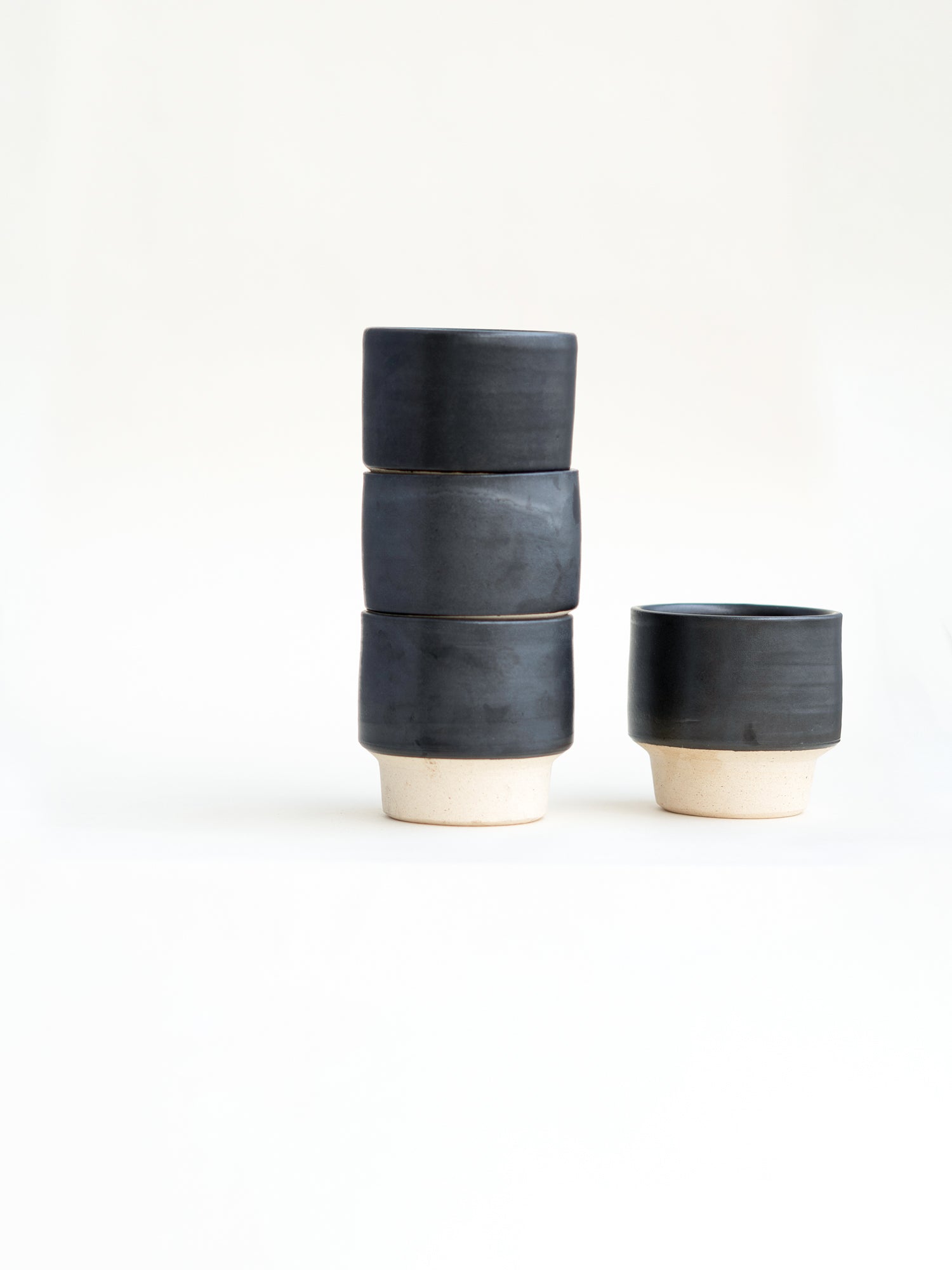 stacked charcoal black coffee cups
