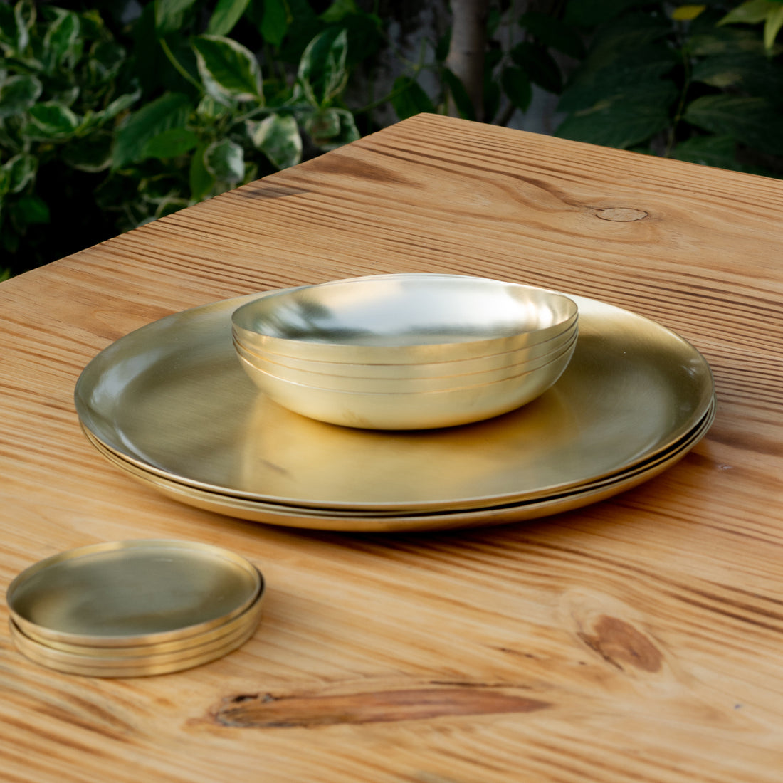 Heirloom Brass Plate with pasta bowls and coasters